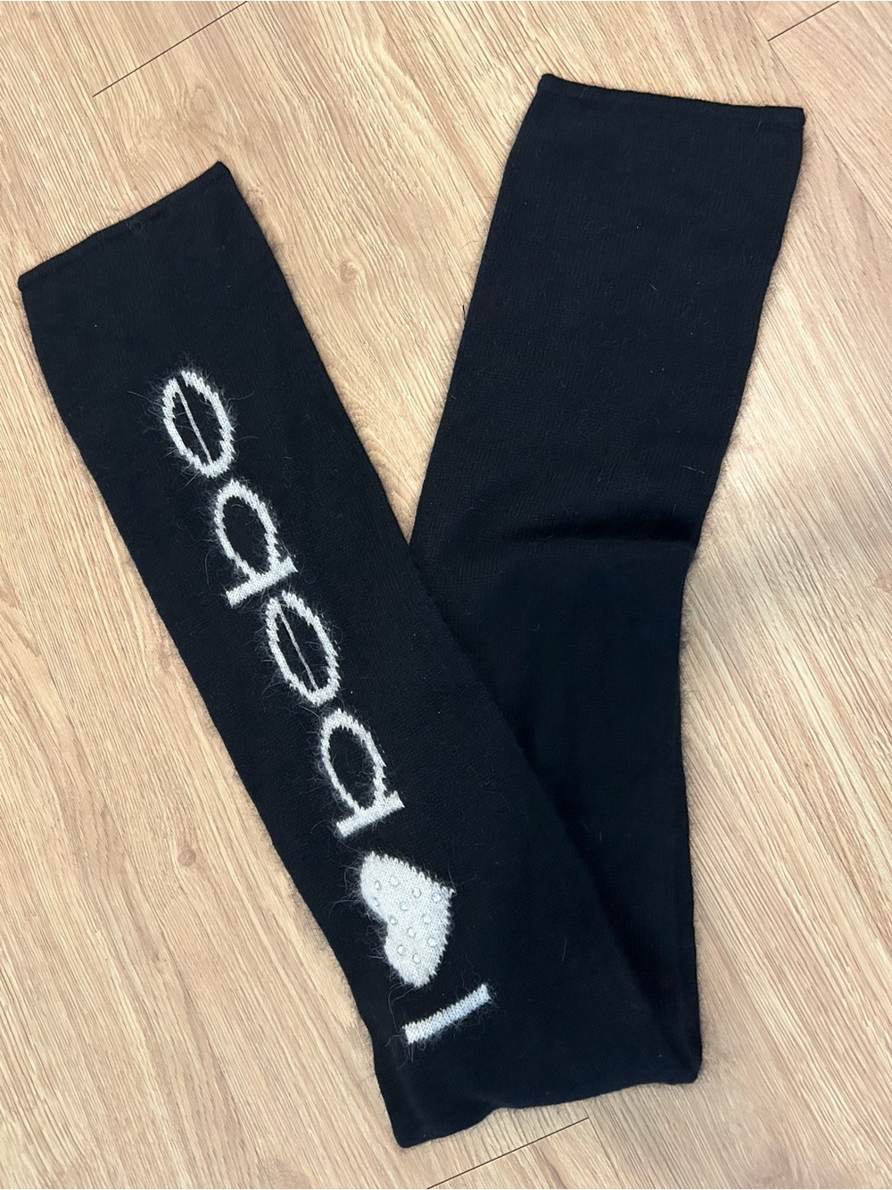 Bebe Black Knit Scarf with White Logo Heart embossed with rhinestones.